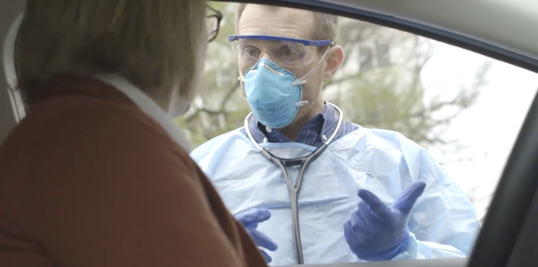 Doctor Speaks With Patient at COVID-19 Testing Clinic