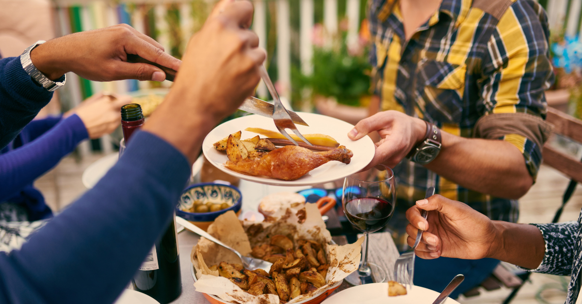 Family shares a meal outdoors