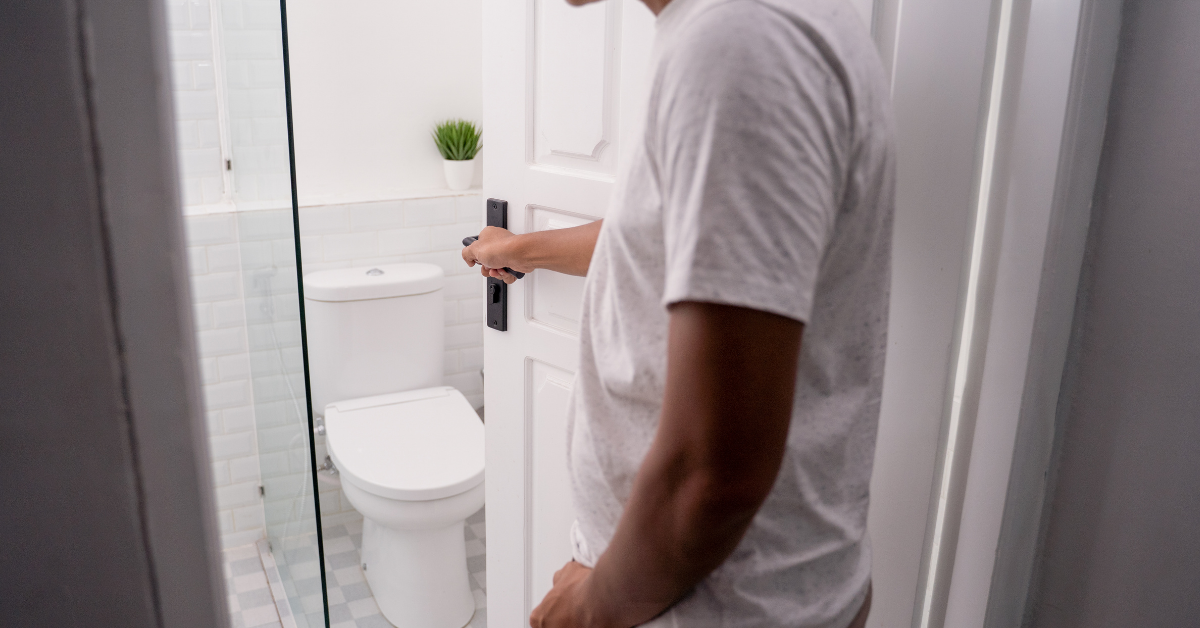 Man opening bathroom door