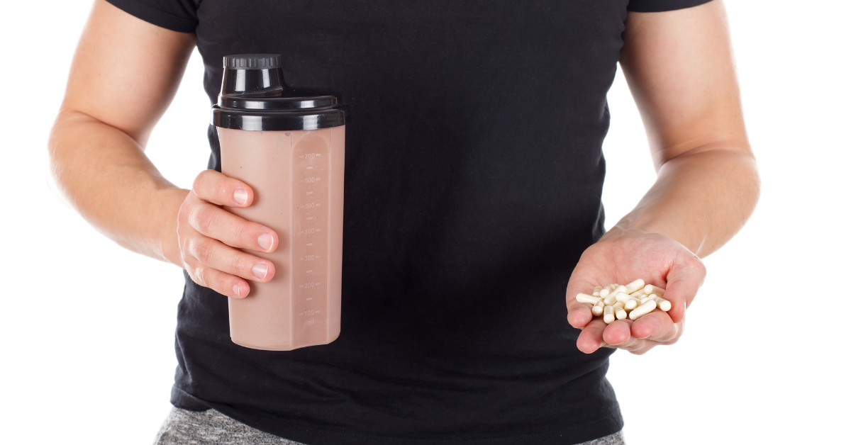 Man holding pills and a shake
