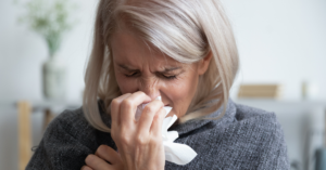 Woman coughs and uses and tissue