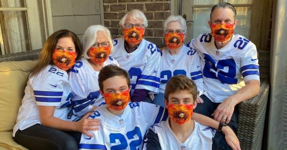 Doctor Barnard and family pose for a photo at Thanksgiving in turkey masks and Cowboys jerseys