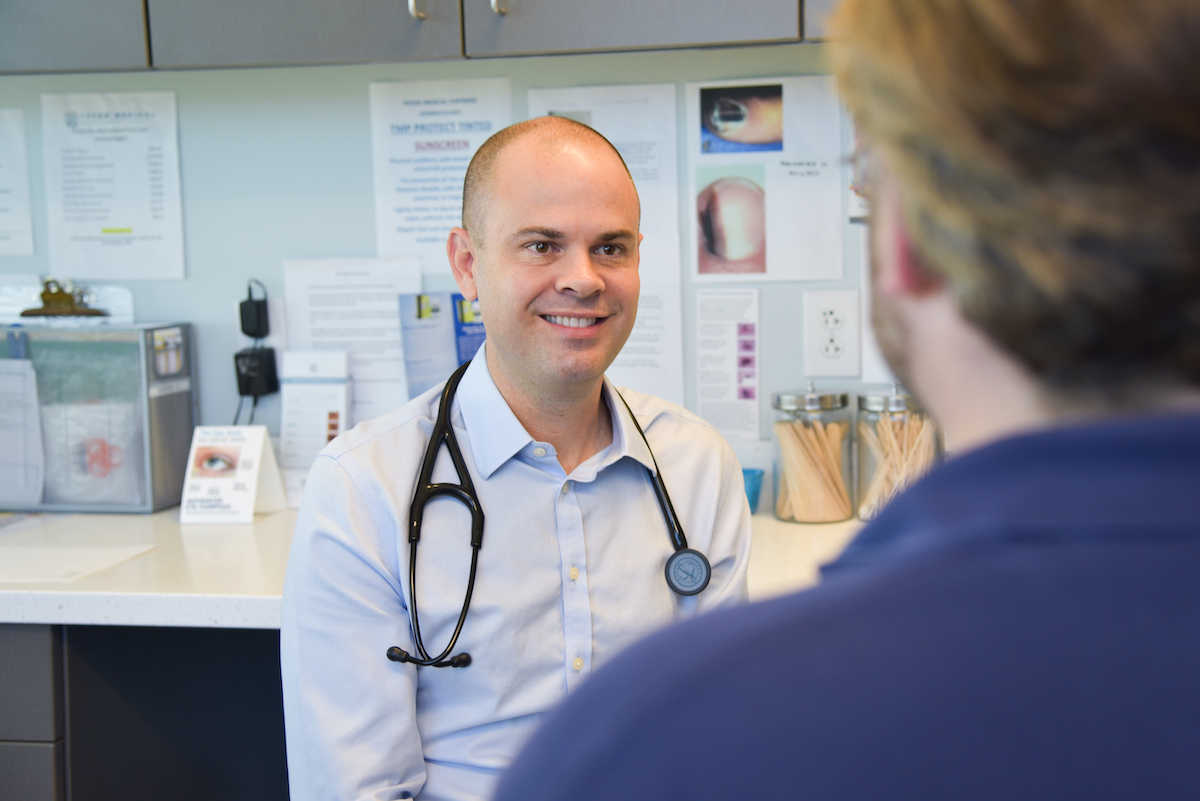 Tryon doctor Robert Brownlee, MD, speaks to a male patient