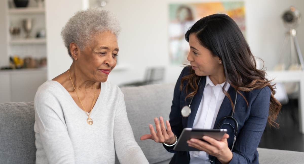 A physician discusses prevention and treatment of osteoporosis with an older female patient