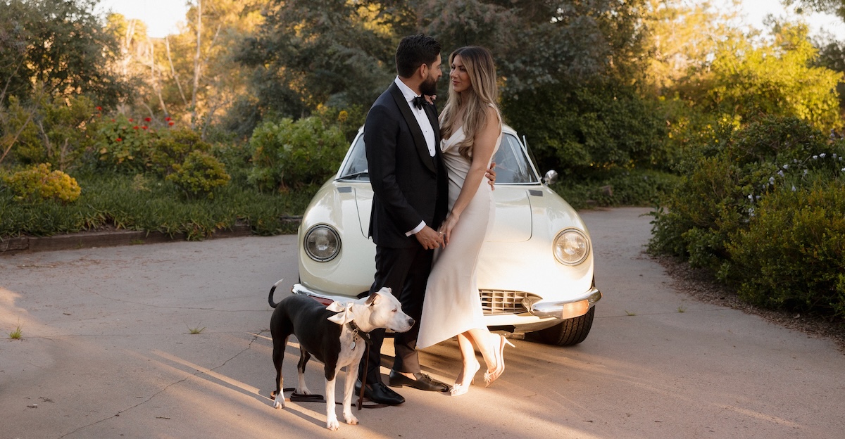 David Echeverri and Ashley Hunter, a married couple and both physicians at Tryon Medical Partners, pose for their wedding photo outdoors with their dog